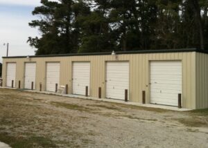 Versatile steel storage building featuring multiple roll-up units, offering secure, cost-effective space solutions for personal storage, equipment, vehicles, and business inventory.