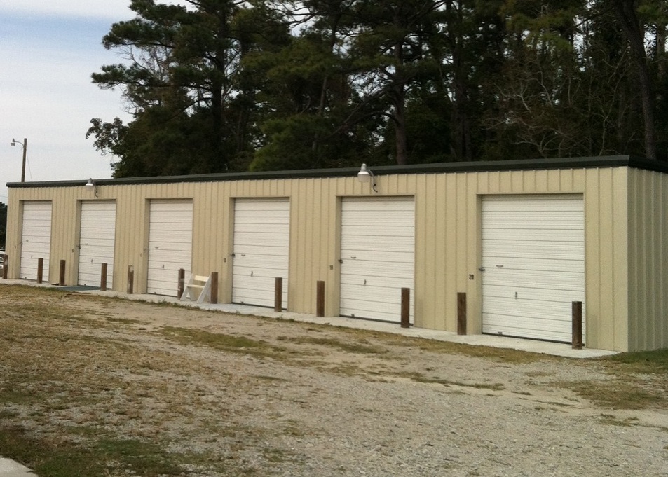 Versatile steel storage building featuring multiple roll-up units, offering secure, cost-effective space solutions for personal storage, equipment, vehicles, and business inventory.